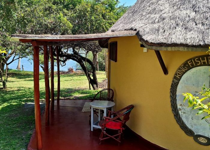 Lakeside guest room with African thatched roof